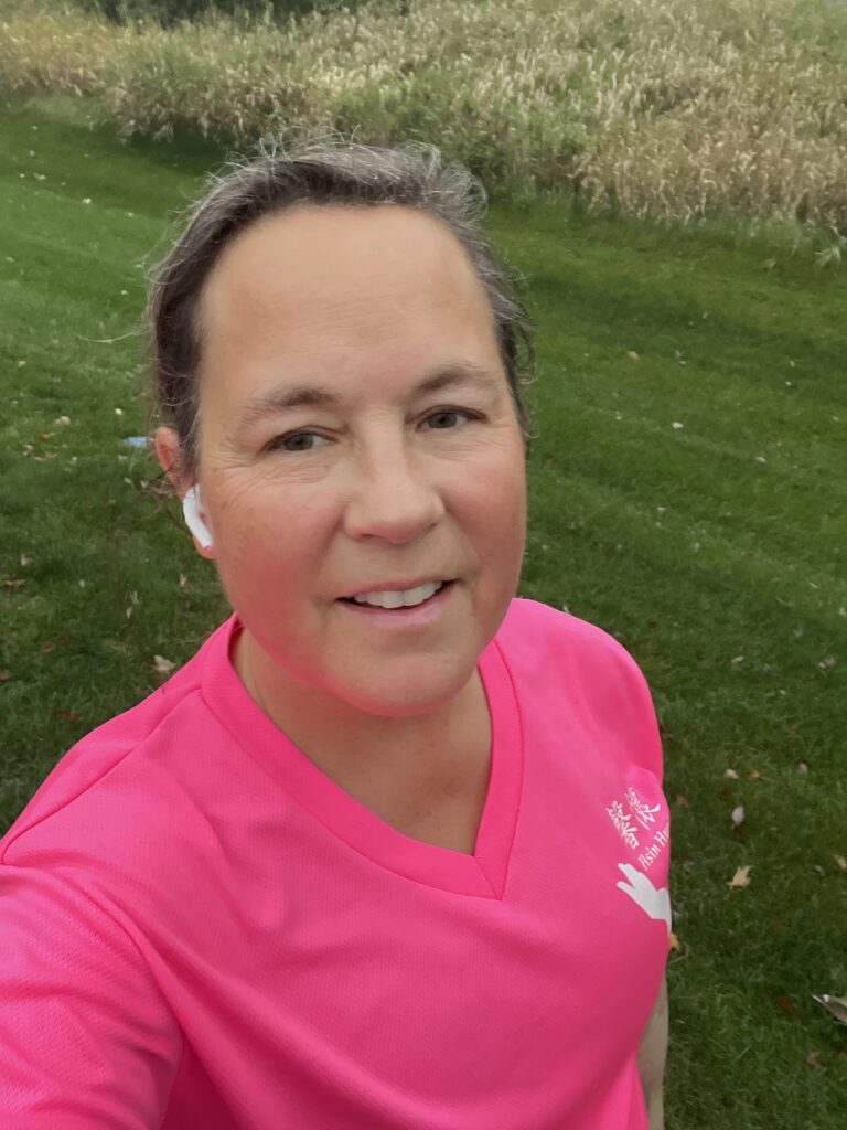 Selfie following a run. Green grass in the background.